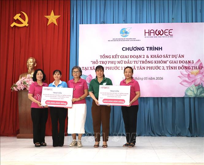 Hội nữ doanh nhân thành phố Hồ Chí Minh trao bảng biểu trưng hỗ trợ vốn cho Hội Liên hiệp Phụ nữ xã Tân Phước 1 và Tân Phước 2. Ảnh: Hồng Nhung - TTXVN
