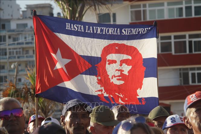 Quốc kỳ Cuba in hình ảnh nhà cách mạng Che Guevara cùng câu nói nổi tiếng của ông - “Hasta la victoria siempre!” (Đến tận chiến thắng, mãi mãi!), trong cuộc mít tinh trên Quảng trường Phản đế, La Habana. Ảnh: Ngọc Duy - PV TTXVN tại Cuba
