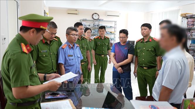 Cơ quan Cánh sát điều tra, Công an thành phố Cần Thơ triển khai các quyết định đối với Trần Minh Trường. Ảnh: TTXVN phát