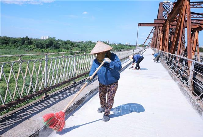 Những công nhân đang làm việc trên công trường cầu Long Biên trong cái nắng gay gắt tới 40 độ C, trưa 24/5. Ảnh: Hoàng Hiếu - TTXVN