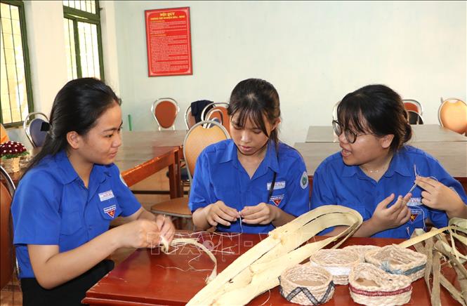 Học sinh Trường THPT Sơn Hà tách sợi vỏ keo để xử lý, tạo sản phẩm. Ảnh: Đinh Hương - TTXVN