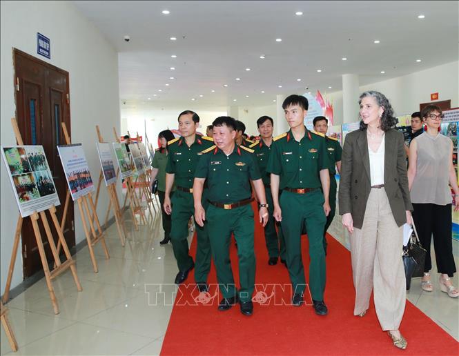 Các đại biểu tham quan triển lãm ảnh về hoạt động phòng tránh bom mìn ở Việt Nam. Ảnh: Trọng Đức - TTXVN