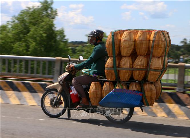 Xe gắn máy chở hàng công kềnh trên Quốc lộ 61, đoạn qua xã Hỏa Lựu, thành phố Cần Thơ. Ảnh: Duy Khương – TTXVN