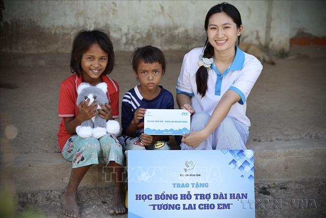 Thành viên “Dự án cho em” trao học bổng hỗ trợ trẻ em vùng cao. Ảnh: TTXVN phát