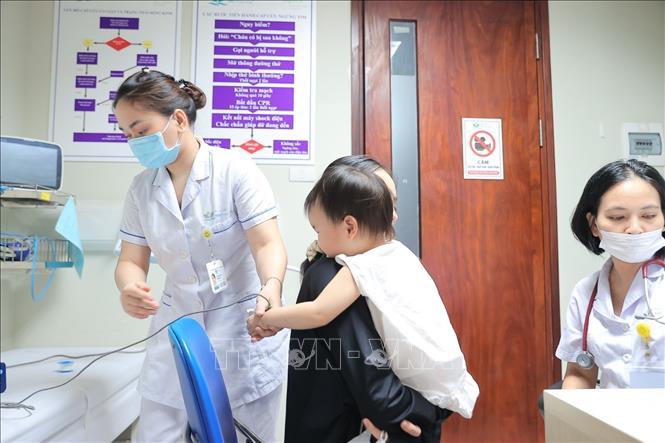 Bác sĩ bệnh viện Nhi Trung ương khám cho bệnh nhi. Ảnh: Minh Quyết - TTXVN