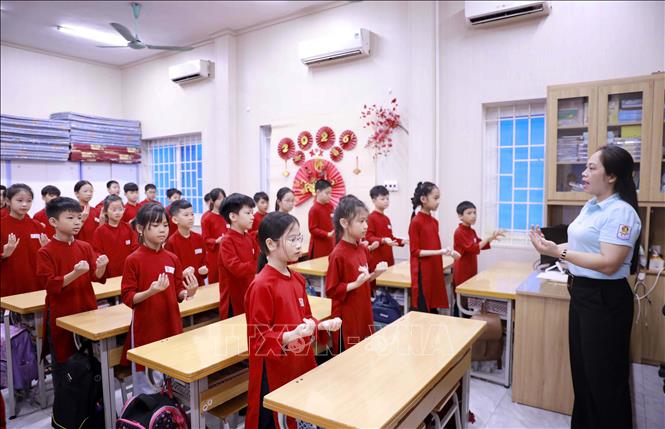 Tiết học truyền dạy hát Xoan tại Trường Tiểu học Gia Cẩm phường Việt Trì, nơi các học sinh trong trang phục áo dài truyền thống chăm chú thực hành theo hướng dẫn của giáo viên âm nhạc. Ảnh: Hoàng Hùng – TTXVN