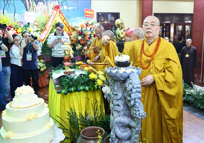 Các đại biểu và Phật tử thực hiện nghi thức tắm Phật. Ảnh: Minh Đức - TTXVN
