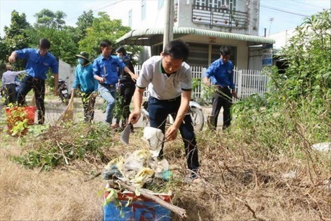 Đoàn viên thanh niên tham gia dọn vệ sinh, thu gom rác thải trên các tuyến đường nội ô thị trấn Châu Thành (Sóc Trăng) sau Lễ phát động hưởng ứng ngày Môi trường Thế giới năm 2017 với chủ đề “Sống với thiên nhiên”.Ảnh: Hoài Thu - TTXVN