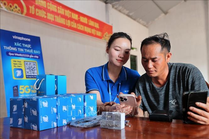 Nhân viên VNPT Lào Cai hỗ trợ xác thực sinh trắc học, chuẩn hóa thông tin thuê bao cho người dân tại điểm xác thực lưu động Sân Bay, xã Bắc Hà, tỉnh Lào Cai. Ảnh: Minh Quyết – TTXVN