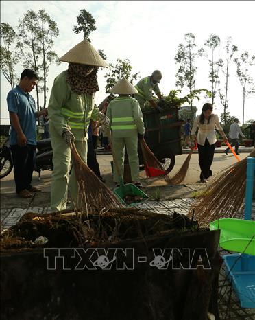 Cán bộ và nhân dân phường Vị Thanh tham gia dọn dẹp vệ sinh môi trường công cộng trên địa bàn. Ảnh: Duy Khương – TTXVN