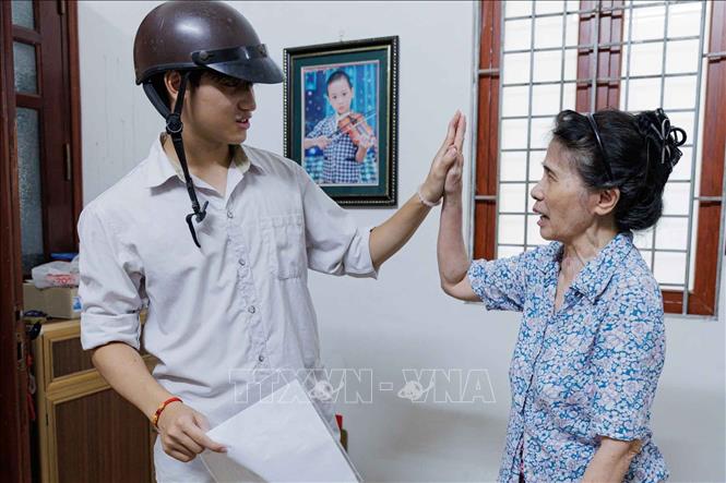 Một cái chạm tay, một lời chúc từ bà nội trở thành nguồn động viên giản dị nhưng ấm áp với sĩ tử trước giờ thi. Ảnh: Phạm Tuấn Anh - TTXVN
