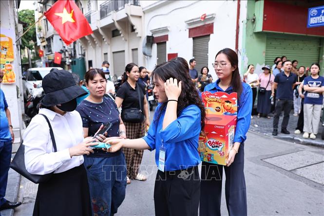 Lực lượng thanh niên tình nguyện tham gia hỗ trợ người nhà thí sinh tại điểm thi Trường THCS Ngô Sĩ Liên, phường Cửa Nam (Hà Nội). Ảnh: Minh Đức - TTXVN