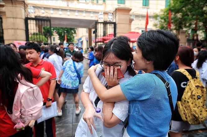 Phu huynh hào hứng khi biết kết quả làm bài thi của con. Ảnh: Phạm Tuấn Anh - TTXVN