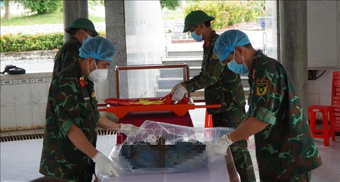 Lực lượng chức năng tỉnh Đồng Tháp thực hiện nhiệm vụ khai quật, lấy mẫu hài cốt liệt sĩ phục vụ giám định AND để xác định danh tính. Ảnh: Nhựt An - TTXVN