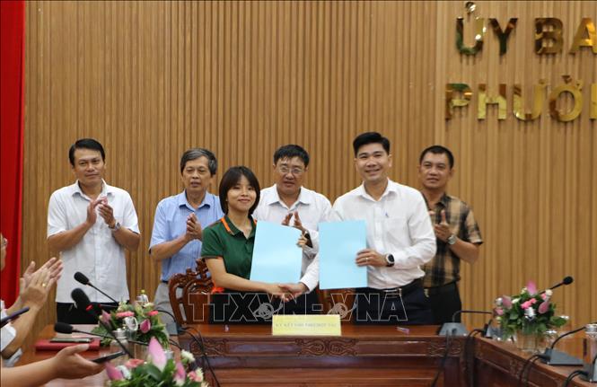 Đại diện hợp tác xã, nhà phân phối ký kết ghi nhớ hợp tác kết nối cung cầu sản phẩm sen, sản phẩm OCOP. Ảnh: Hồng Thái - TTXVN