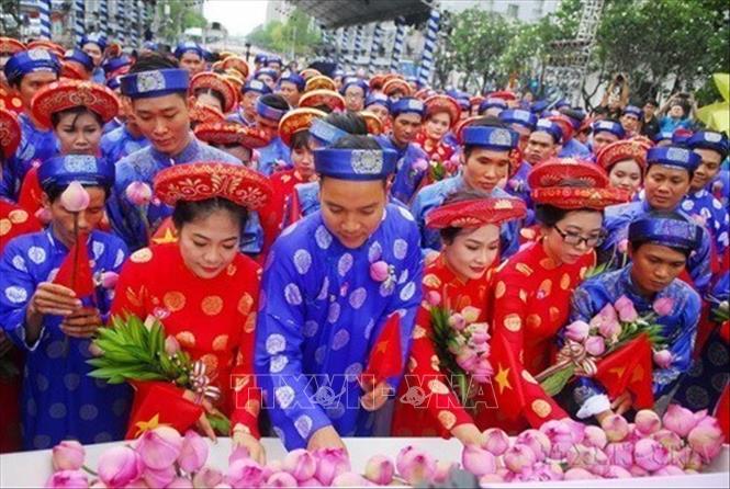 Các đôi uyên ương dâng hoa tại Tượng đài Bác Hồ tại “Lễ cưới tập thể - Tôn vinh nét đẹp văn hóa Việt” dành cho 100 cặp đôi uyên ương, để kết nối hạnh phúc cho các bạn thanh niên công nhân, thanh niên có hoàn cảnh khó khăn đang làm việc tại các khu chế xuất, khu công nghiệp, trường học.. tại TP. Hồ Chí Minh. Ảnh: Mạnh Linh - TTXVN