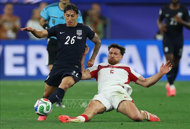 Pha tranh bóng giữa cầu thủ Alex Zendejas (trái) đội tuyển Mỹ và Salih Ozcan đội tuyển Thổ Nhĩ Kỳ. Ảnh: THX/TTXVN