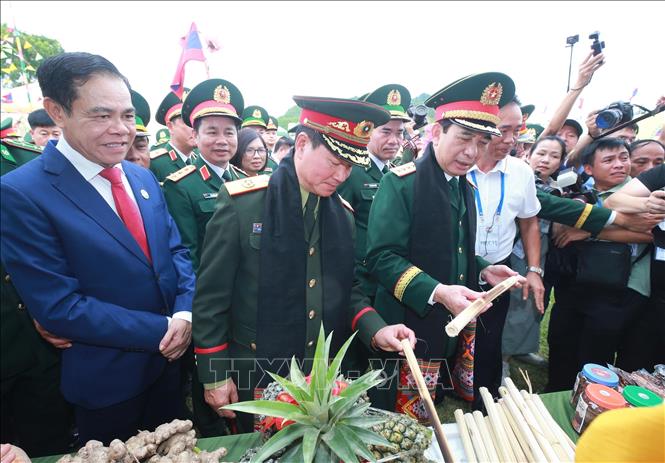 Hai Phó Thủ tướng, Bộ trưởng Bộ Quốc phòng tham quan khu trưng bày hàng nông sản của nhân dân địa phương.  Ảnh: Trọng Đức - TTXVN