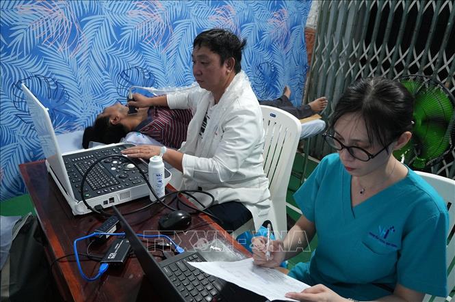 Bác sĩ siêu âm cho đoàn viên, người lao động. Ảnh: Lê Huy Hải - TTXVN