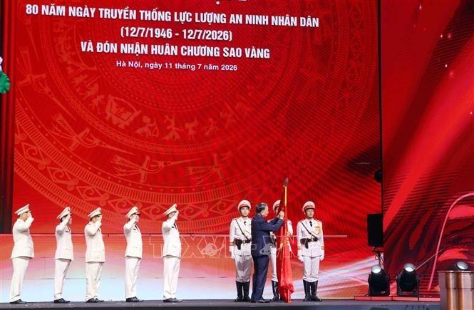 Tổng Bí thư, Chủ tịch nước Tô Lâm gắn Huân chương Sao Vàng lên lá cờ truyền thống của lực lượng An ninh nhân dân tại Lễ kỷ niệm 80 năm Ngày truyền thống lực lượng (12/7/1946 - 12/7/2026). Ảnh: Phạm Kiên - TTXVN