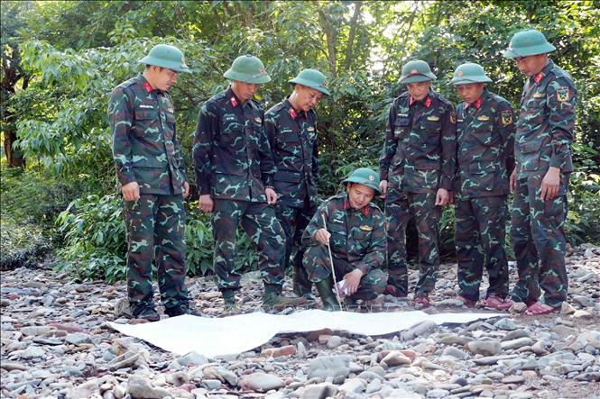 A team from the Military Region 4 determines the orientation and location for the search of fallen soldiers' remains. VNA Photo