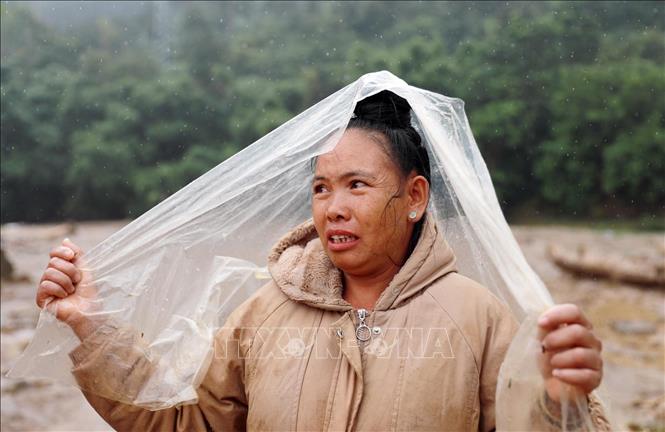 Người dân xã Mường Than thất thần sau khi nhà cửa bị tàn phá do lũ giữ và hiện có một cháu đang mất tích chưa tìn thấy. Ảnh: Quý Trung - TTXVN