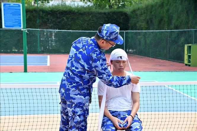 Giáo viên hướng dẫn kỹ thuật cơ bản về sơ cứu, cấp cứu ban đầu đối với thương binh, người bị thương, bị nạn trong quá trình thực hiện nhiệm vụ. Ảnh: TTXVN phát
