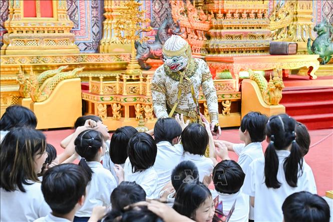 Nghệ sĩ kịch múa mặt nạ Khon giao lưu cùng các học sinh trong một buổi biểu diễn. Ảnh: Phạm Hải - PV TTXVN tại Thái Lan