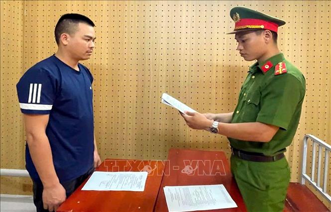 Công an đọc quyết định khởi tố Bùi Công Dũng. Ảnh: TTXVN phát