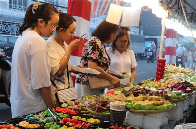  Du khách mua sắm, thưởng thức ẩm thực tại Lễ hội Ẩm thực “Hương Sắc Tây Đô 2026”. Ảnh: Nguyễn Hằng - TTXVN