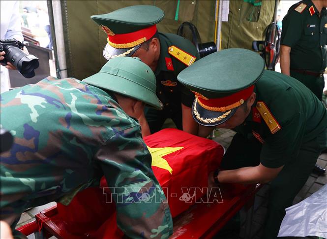 Trang trọng thực hiện quy trình khai quật, đưa hài cốt liệt sĩ chưa xác định danh tính về khu vực lấy mẫu sinh phẩm sĩ tại Nghĩa trang liệt sĩ Ngọc Hồi (xã Thanh Trì). Ảnh: Văn Điệp – TTXVN