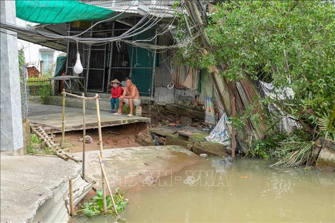 Tuyến đường bê tông qua khu vực đông dân cư ở gần bến phà Mang Cá (xã Đại Hải) bị chia cắt hoàn toàn do sạt lở. Ảnh: Thanh Liêm - TTXVN
