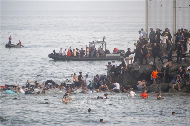 Hàng trăm người di cư tìm cách bơi từ Maroc sang Ceuta, vùng lãnh thổ của Tây Ban Nha ở Bắc Phi, ngày 30/7/2026. Ảnh: AA/TTXVN phát