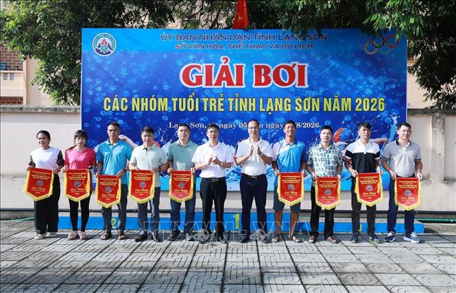 Đại diện các đoàn vận động viên nhận Cờ lưu niệm của Ban tổ chức. Ảnh: Anh Tuấn – TTXVN