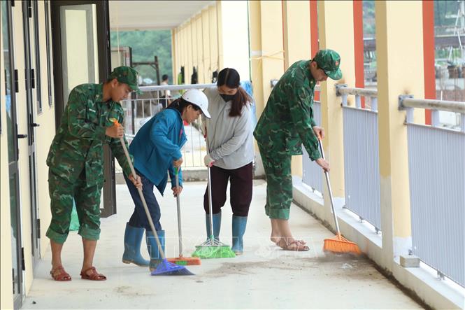 Lực lượng BĐBP Lạng Sơn phối hợp cùng phụ huynh học sinh để dọn dẹp lớp học Trường phổ thông nội trú liên cấp xã biên giới Mẫu Sơn (Lạng Sơn) đang dần hoàn thiện. Ảnh: Quang Duy - TTXVN