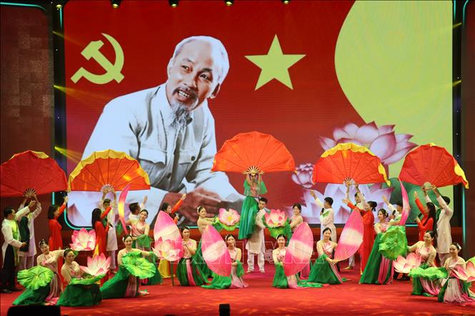 Không gian sân khấu rực rỡ sắc màu với cờ Đảng, cờ Tổ quốc và hoa sen, thể hiện tình yêu quê hương, đất nước qua những điệu dân ca. Ảnh: Hoàng Ngà - TTXVN