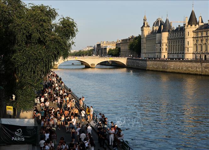 Người dân tránh nóng bên bờ sông Seine tại thủ đô Paris, Pháp. Ảnh: THX/TTXVN phát