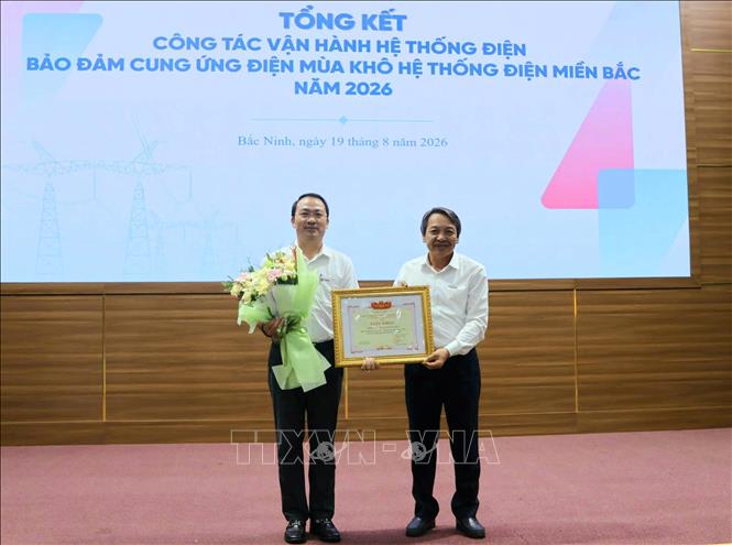 Đại diện Công ty TNHH một thành viên Vận hành hệ thống điện và thị trường điện quốc gia (NSMO) trao Giấy khen cho các đơn vị. Ảnh: Đồng Thúy - TTXVN