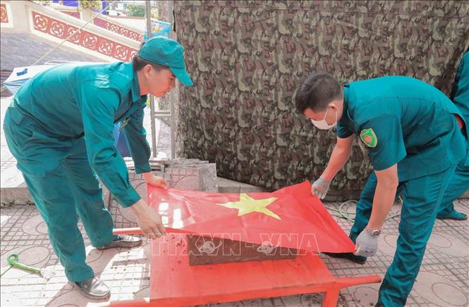 Thực hiện nghi thức phủ Quốc kỳ trang trọng, tri ân Anh hùng liệt sĩ đã hy sinh vì độc lập, tự do của Tổ quốc tại Nghĩa trang liệt sĩ Minh Phú, xã Kim Anh, Hà Nội. Ảnh: Phan Phương - TTXVN