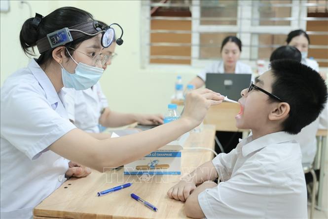 Bác sĩ bệnh viện đa khoa Xanh Pôn khám cho học sinh tại trường THCS Ba Đình ngày 22/8/2026. Ảnh: Minh Quyết - TTXVN