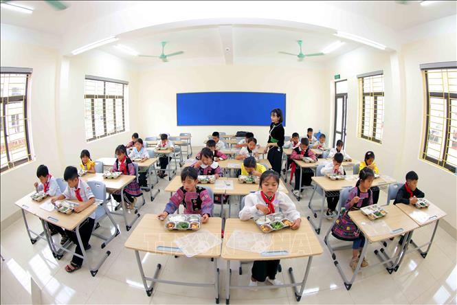 Giờ ăn trưa tại lớp học của trường phổ thông nội trú Tiểu học và Trung học cơ sở Yên Sơn. Ảnh: Quang Quyết - TTXVN

