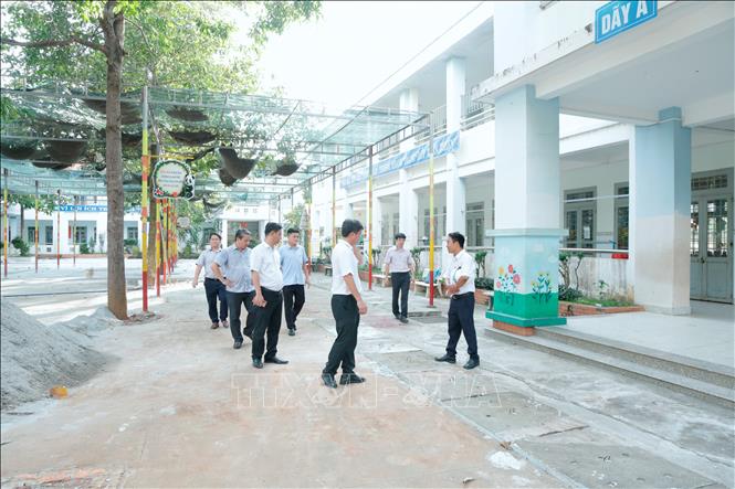 Chủ tịch UBND phường Đồng Xoài Dương Hoài Pha kiểm tra thực tế tiến độ thi công các công trình, dự án đầu tư trên địa bàn. Ảnh: Nhật Bình – TTXVN. 