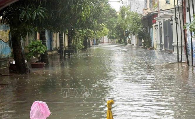 Mưa lớn kéo dài, trên các tuyến phố bị ngập sâu lực lượng chức năng phải giăng dây cảnh báo và không cho các phương tiện qua lại. Ảnh: Việt Hoàng - TTXVN