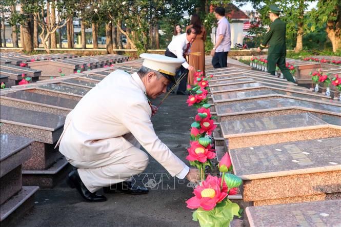 Đại biểu thắp hương tại các phần mộ trong Nghĩa trang liệt sĩ Sóc Trăng. Ảnh: Trung Kiên - TTXVN