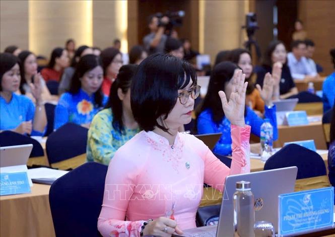 Các đại biểu biểu quyết thông qua Nghị quyết Hội nghị lần thứ hai Ban Chấp hành Trung ương Hội Phụ nữ Việt Nam khóa XIV. Ảnh: Tuấn Anh - TTXVN