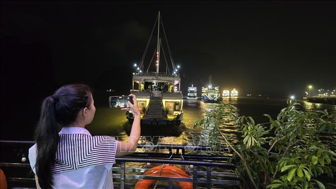 Du khách háo hức chiêm ngưỡng vẻ đẹp lung linh của Di sản thiên nhiên thế giới vịnh Hạ Long về đêm. Ảnh: Thanh Vân - TTXVN