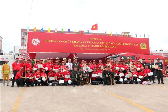 Các lực lượng tham gia diễn tập chữa cháy và cứu nạn, cứu hộ tại Công ty TNHH Timberland chụp ảnh lưu niệm tại buổi diễn tập. Ảnh: Thanh Vũ - TTXVN