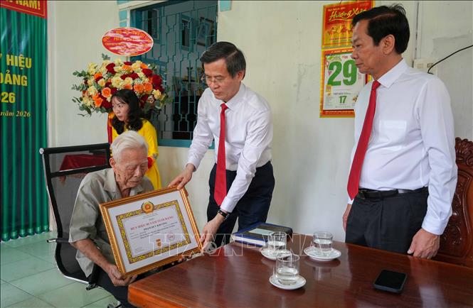 Ông Đoàn Minh Huấn, Ủy viên Bộ Chính trị, Giám đốc Học viện Chính trị Quốc gia Hồ Chí Minh trao chứng nhận 80 năm tuổi Đảng cho đảng viên Phạm Duy Khương. Ảnh: Thanh Liêm - TTXVN