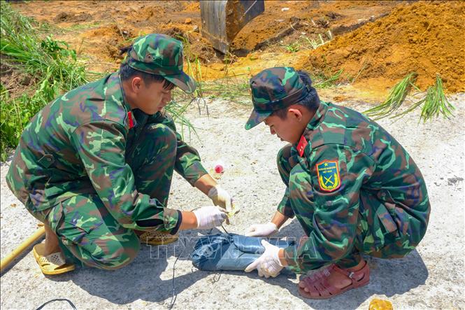 Cán bộ, chiến sĩ Đội K71, Bộ Chỉ huy Quân sự tỉnh Tây Ninh cẩn trọng xử lý các dấu tích trong quá trình đào tìm hài cốt liệt sĩ, bảo đảm đúng quy trình chuyên môn. Ảnh: Minh Phú - TTXVN 