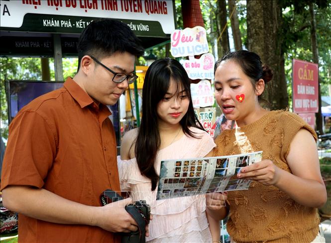 Tại Km0 Hà Giang, du khách được các bạn hướng dẫn viên của Hiệp hội du lịch Tuyên Quang giới thiệu các điểm đến nổi tiếng. Ảnh: Đức Thọ - TTXVN.